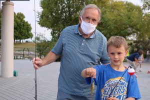 man and boy with fishing rods