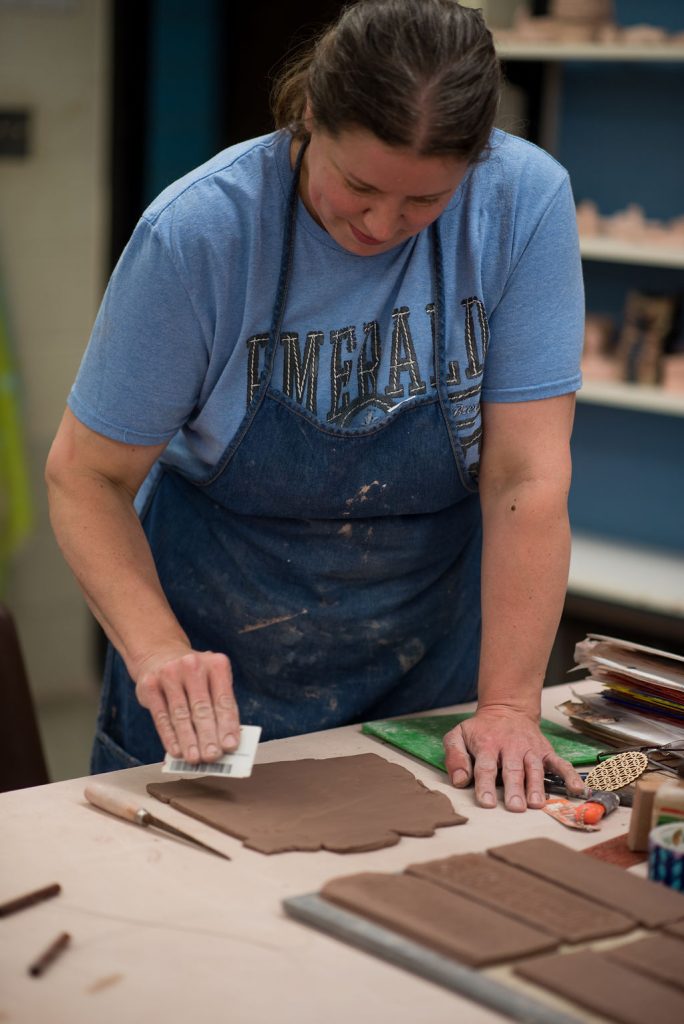 woman doing pottery