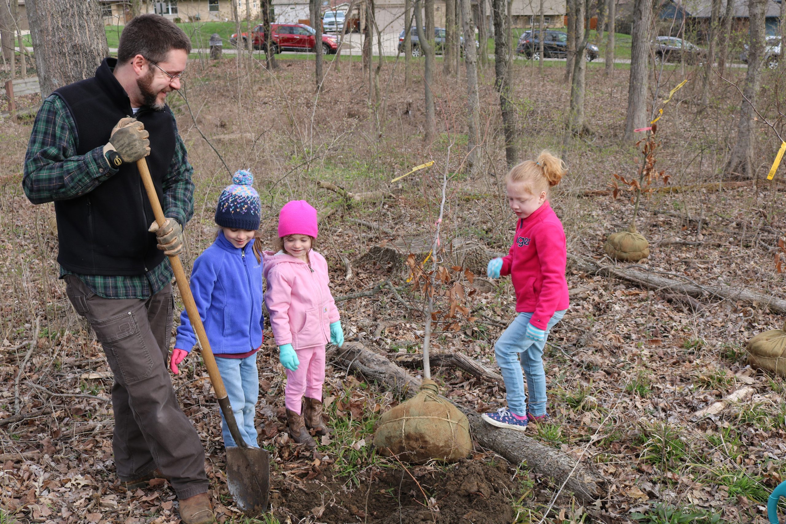 family planting trees