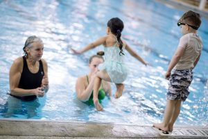 girl jumping in pool