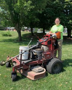 woman mowing grass