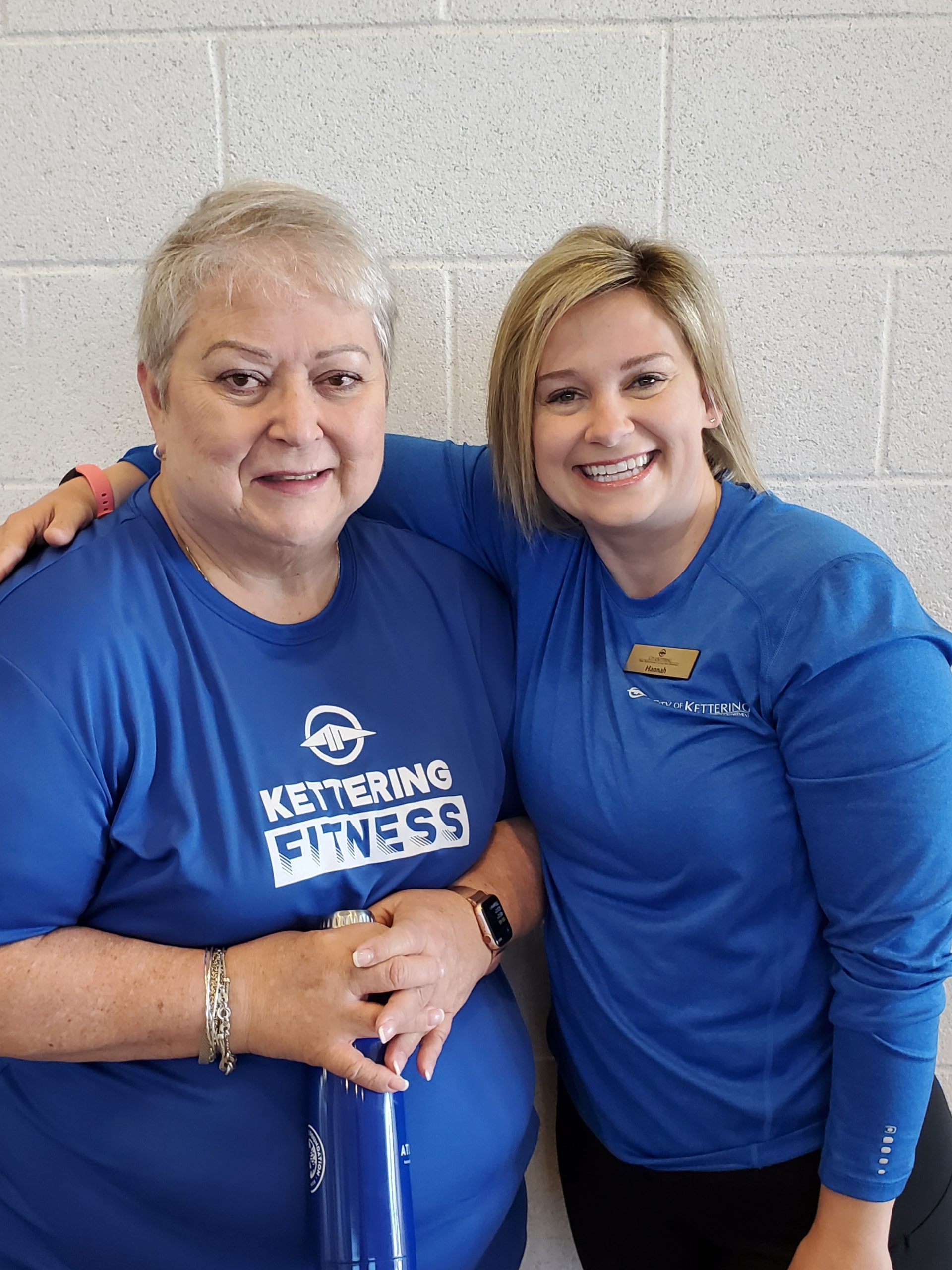 two women in fitness shirts