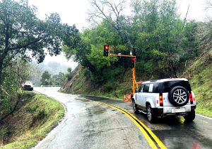 Temporary traffic signals in place on Bolinas Road, near Sky Oaks Road, where the road has been reduced to one lane for alternating traffic flow.