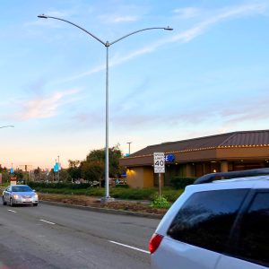 Cars driving along Sir Francis Drake Boulevard passing several of the light poles that will soon be replaced along the medians.