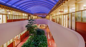 Hallway of Marin County Civic Center, windows show into offices.