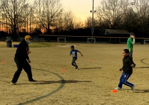 Youth practicing sports at dusk