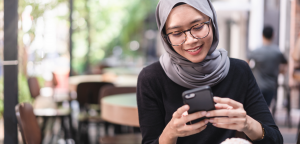 Woman looking at phone smiling