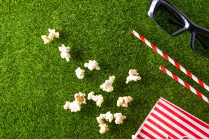 Popcorn and sunglasses on grass