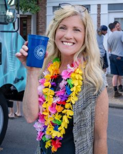 Woman at a luau drinking out of a cup