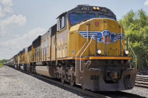 The front engine of a yellow freight train