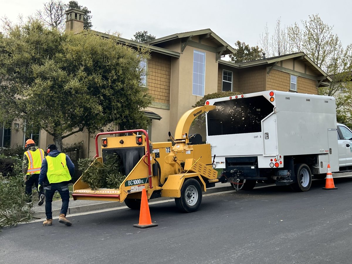 A wood chipper parked on a neighborhood street.