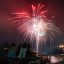 people watching fireworks in the night sky