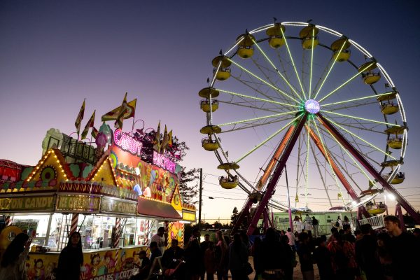 Image of a ferris wheel and food vendor at the Petaluma Fair at dusk