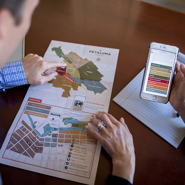 map on desk with hands