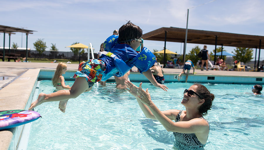 Image of a child jumping into a community pool in Petaluma