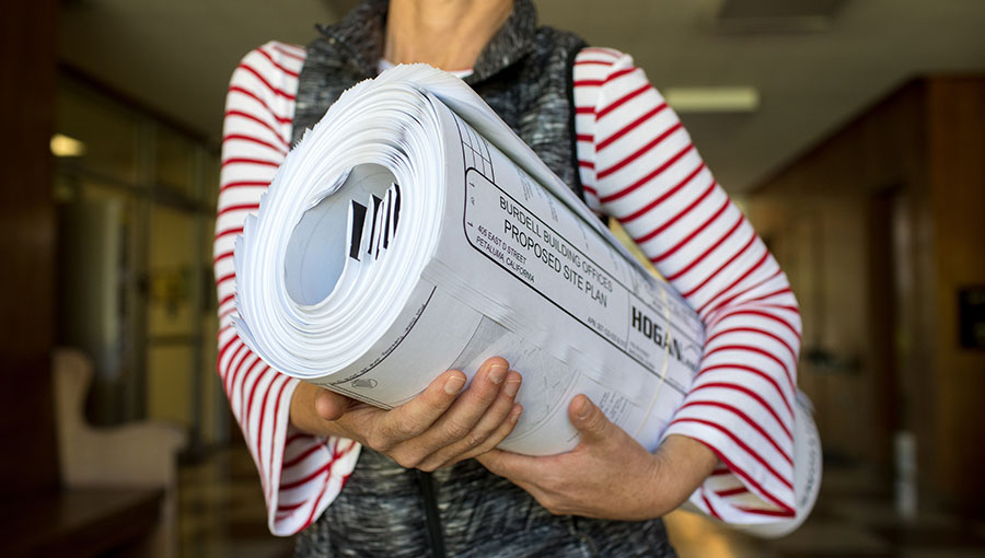 photo of woman with building plan