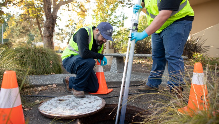 photo of staff checking manhole