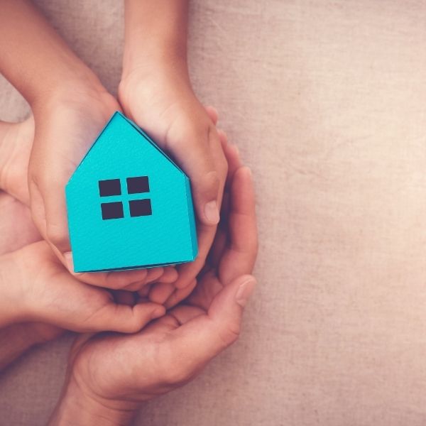 hands holding a paper house