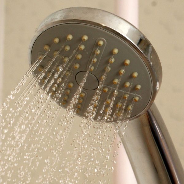 Picture of a shower head with water coming out of it