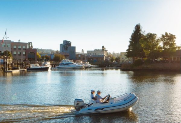 A dinghy floats across the Petaluma River