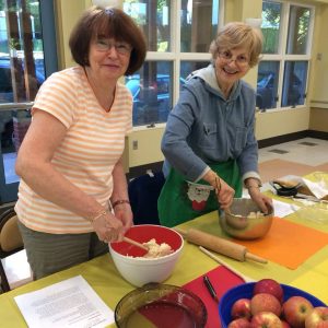 2 women preparing dough to bake