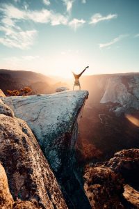 man on a mountain doing cartwheel