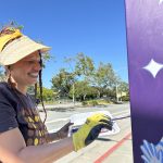 artist paints a utility box