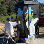 a person paints flowers in a firefighter