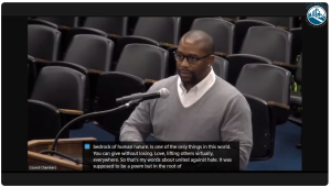 man presenting at city council meeting 