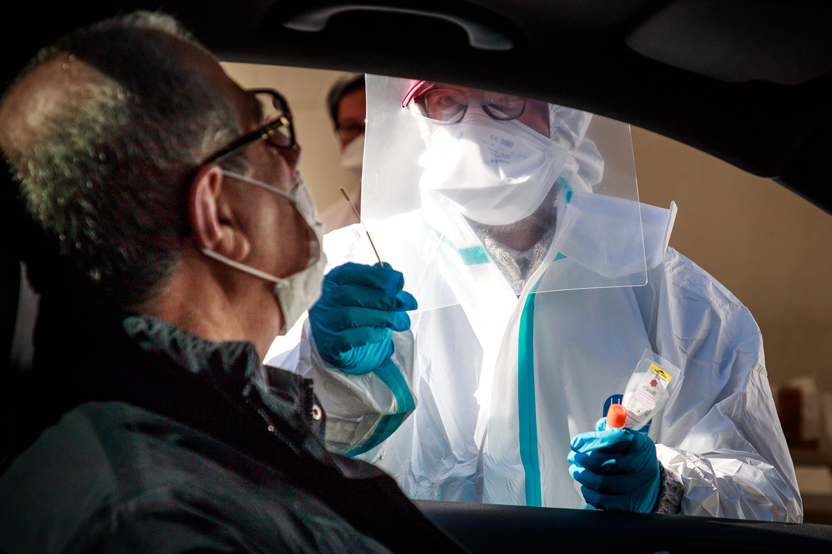 Image of man receiving a drive through covid test