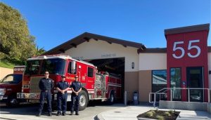 Fire station with fire fighter standing in front