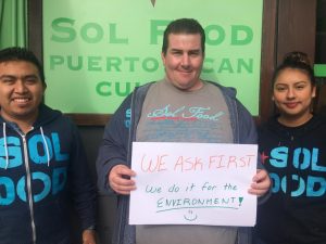 Sol Food employees with Ask First sign