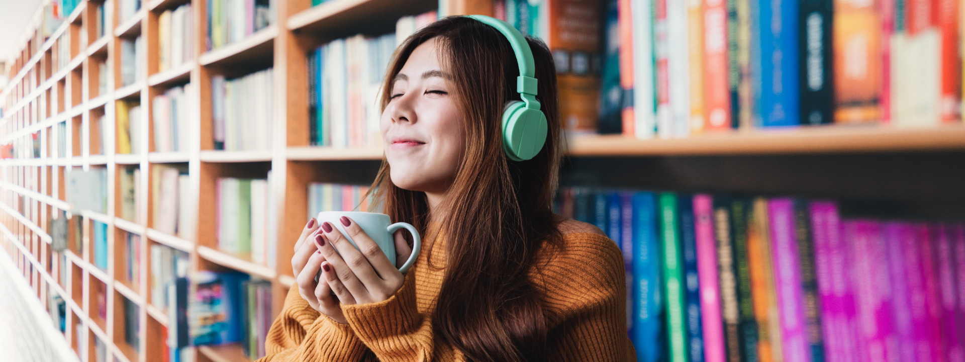 girl with headphones in front of book case