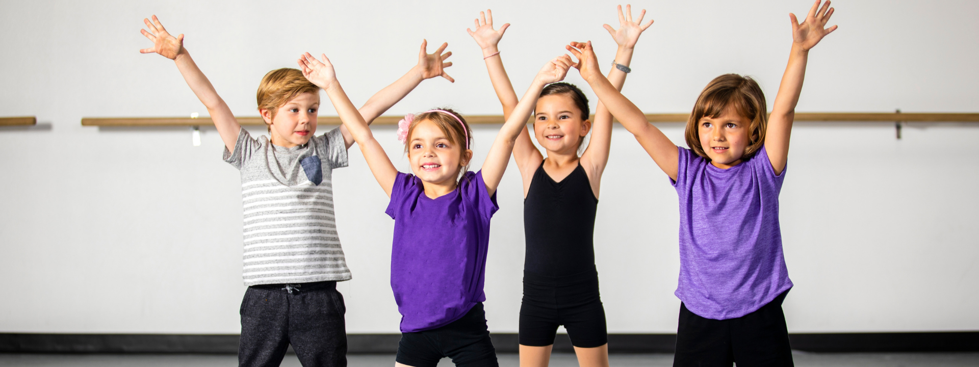 kids with hands up in dance class