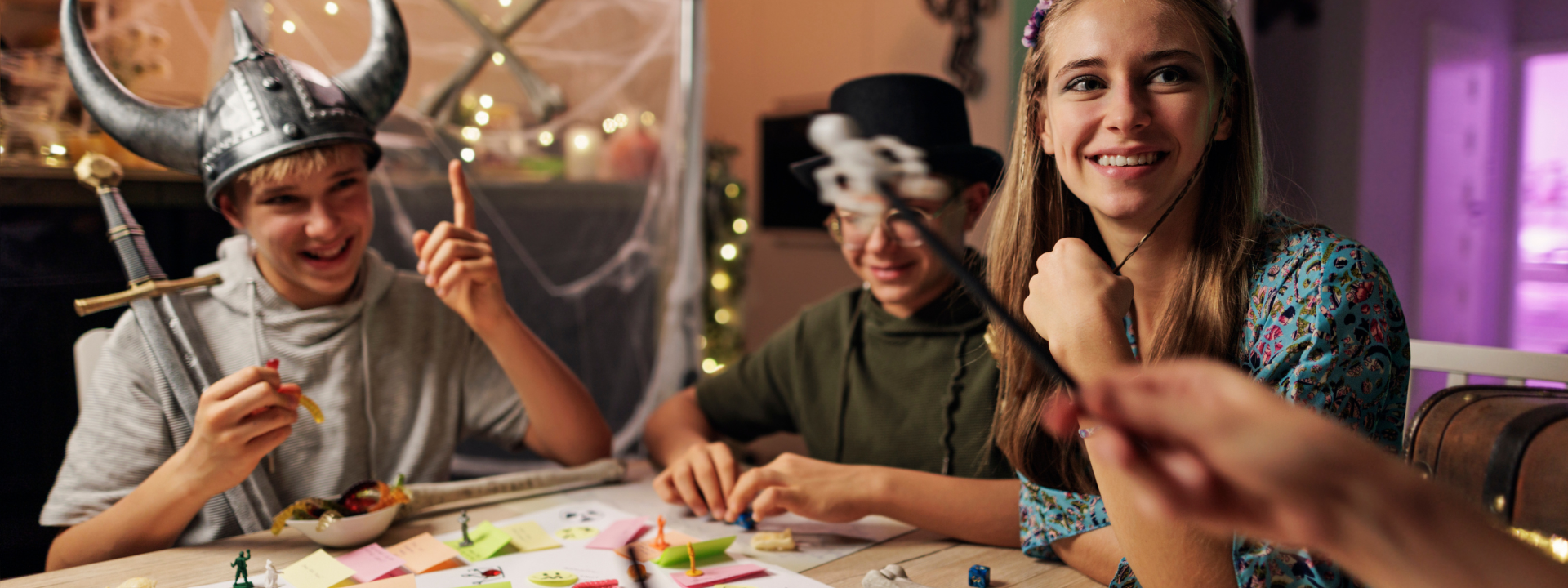 kids in costumes playing a board game