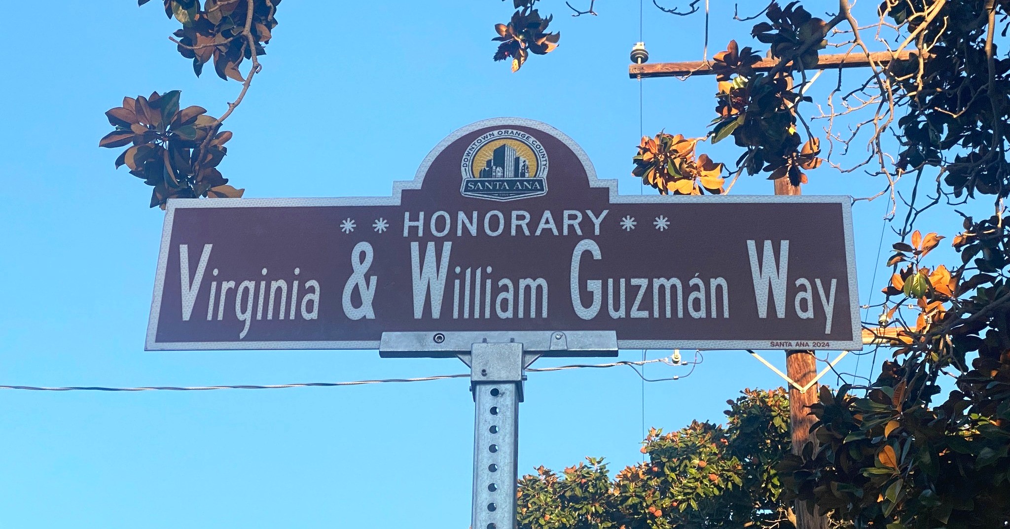 A street sign that says "Honorary Virginia and William Guzman Way."