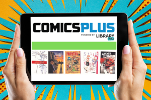 hands holding table with app labeled Comics Plus