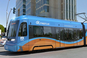 A conceptual photo of the OC Streetcar passing the federal court building