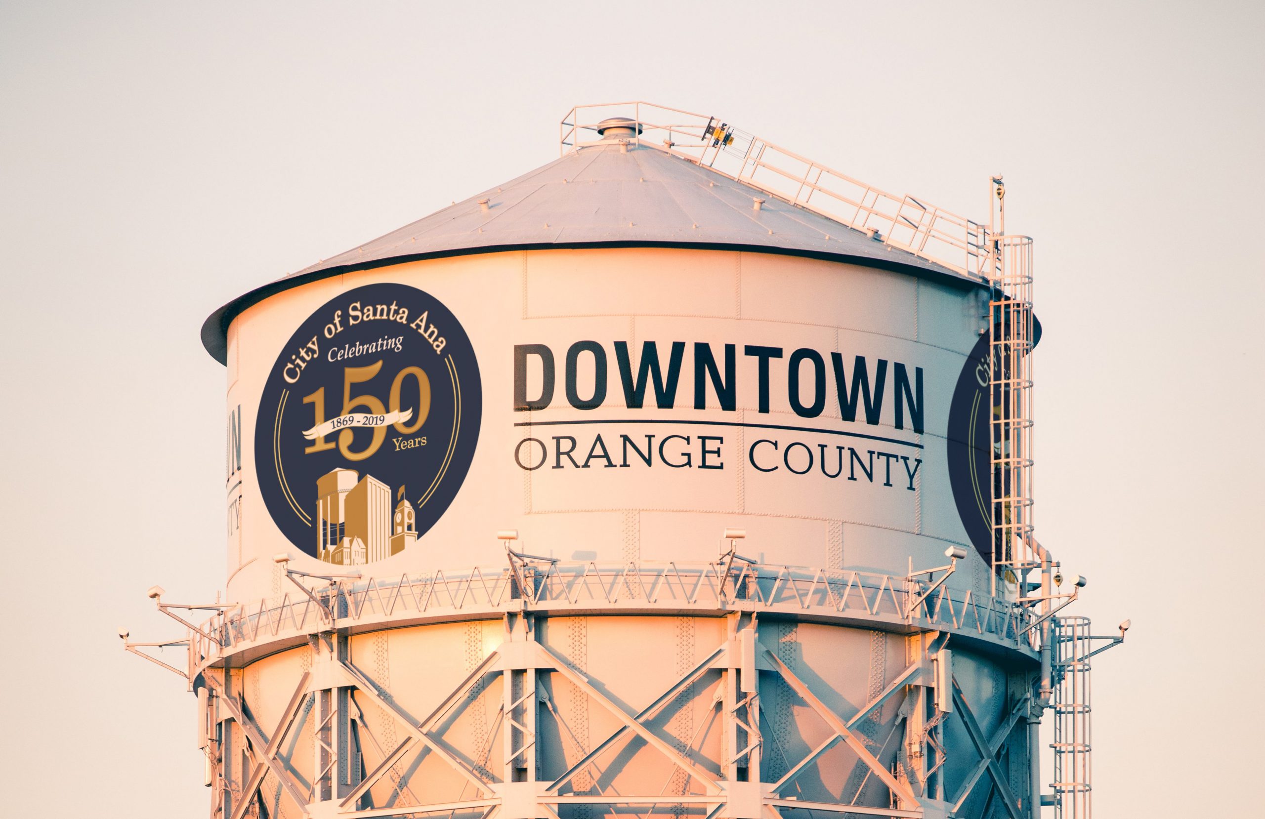 A photograph of the Water Tower with the 150th Logo with a grey sky behind it