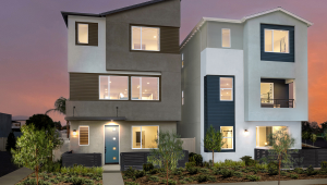 Proposed illustrations of what two different new townhomes will look like. The one on the left is a brown building with large, square windows and a blue front door, and the one on the right is a grey and white building with navy blue areas, and it also has large square windows.