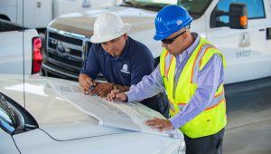 Two employees from PWA reviewing blueprints