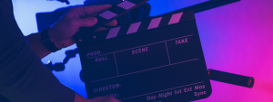 person holding film slate in front of a camera