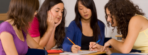 Group of ladies working on sheet of paper