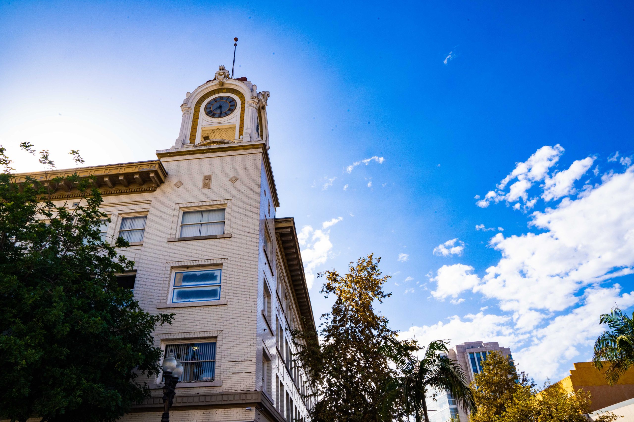 White clocktower with blue sky in background