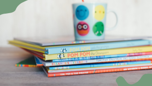 cup on stack of books - -Bundles of Joy