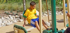 Kid exercising on the outdoor fitness at Garfield Exercise Park