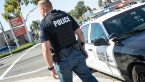 Picture of a SAPD officer next to an police interceptor