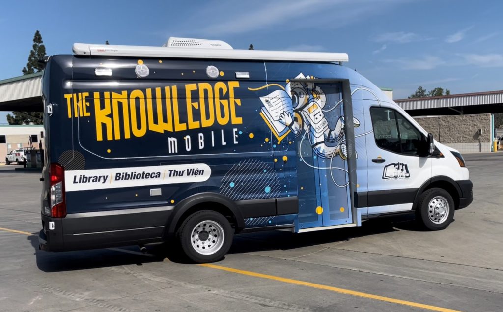 Side of bookmobile with astronaut reading a book