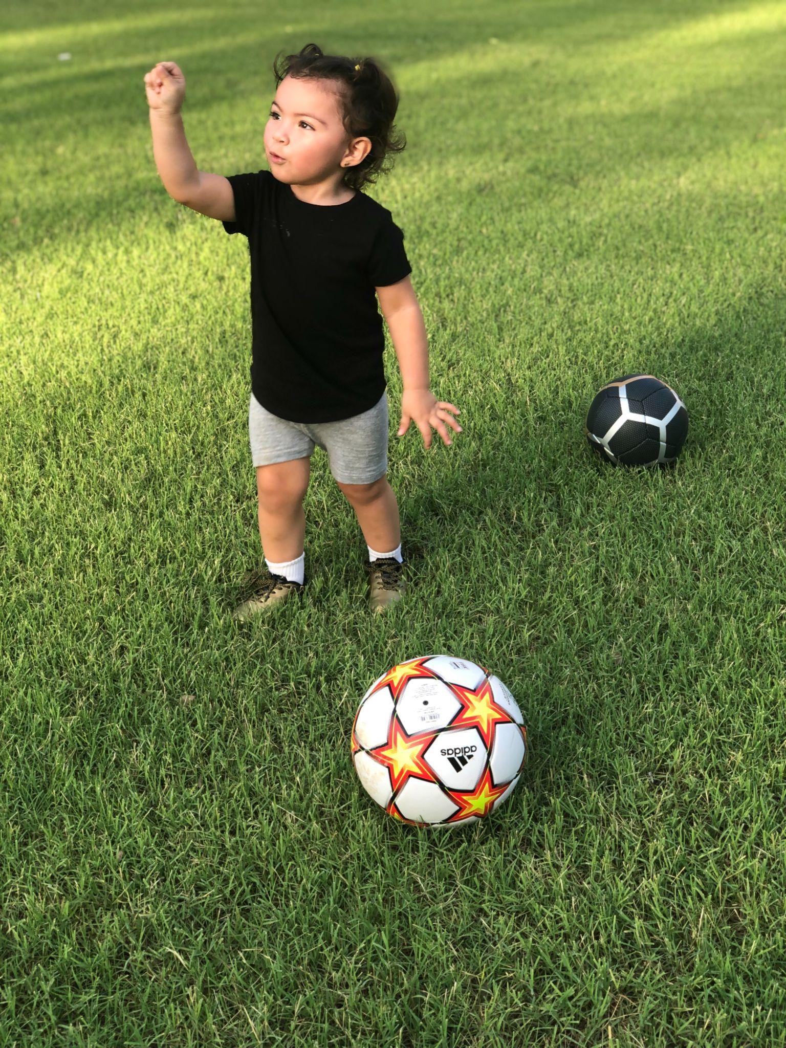 Child with Soccer Ball in Field