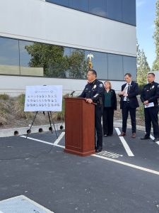 Chief Valentin addressing the media from a wooden podium